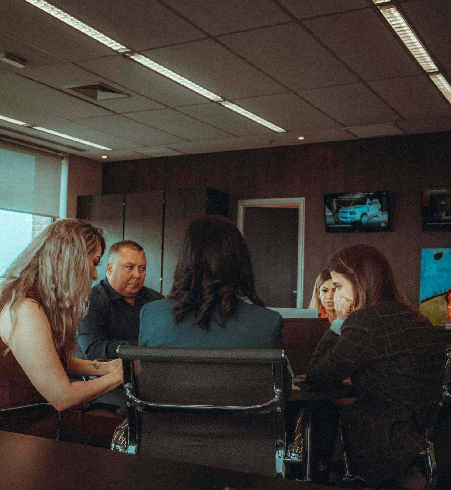 Participants and a mediator in discussion during a mediation session
